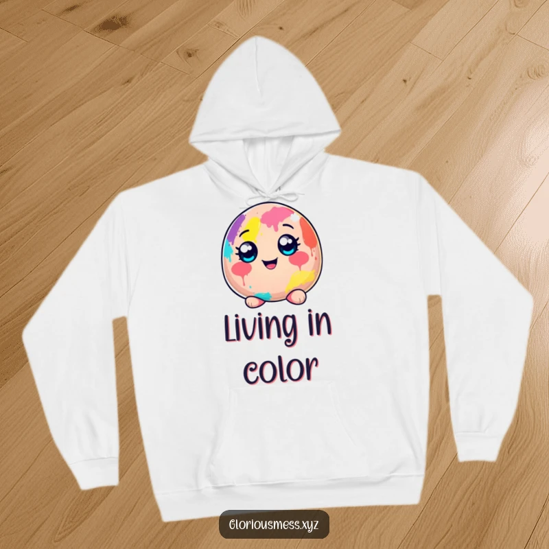 Funny hoodie depicting a cheerful blob character, wide-eyed and covered from head to toe in a delightful mess of colorful paint.