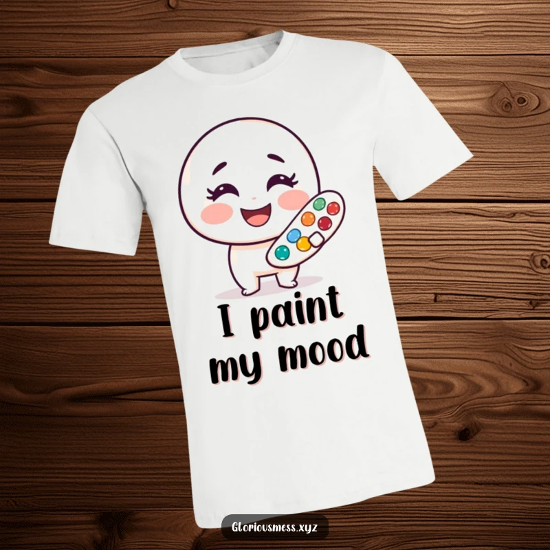 Funny t-shirt with a smudged paint palette character smiling wide, showcasing a cheerful and artistic personality, a great funny gift.